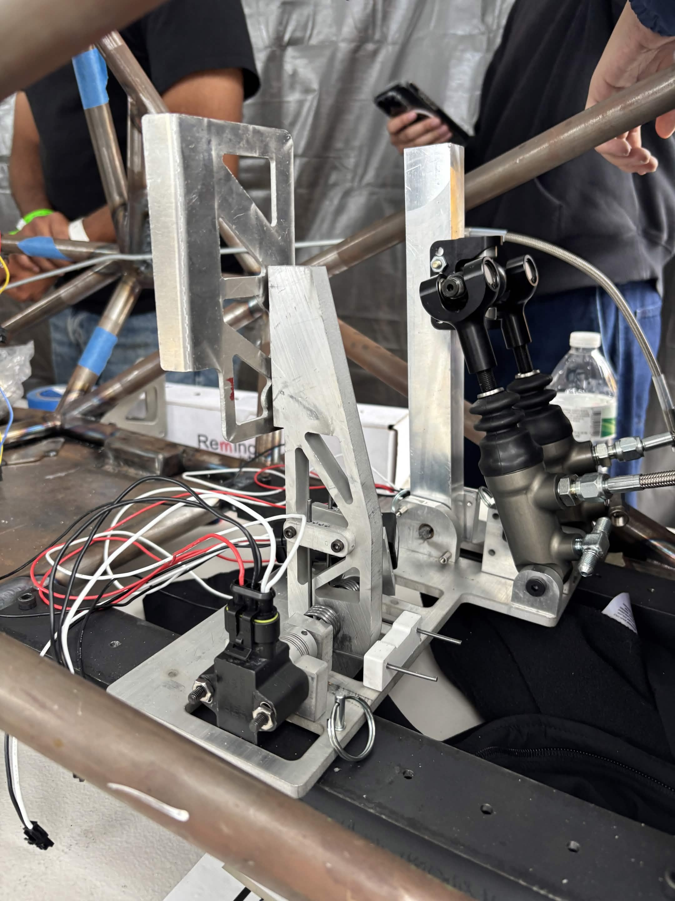 Finished pedalbox that went on the car — side view showing the brake pedal, throttle lever, master cylinders, and quick release pins.