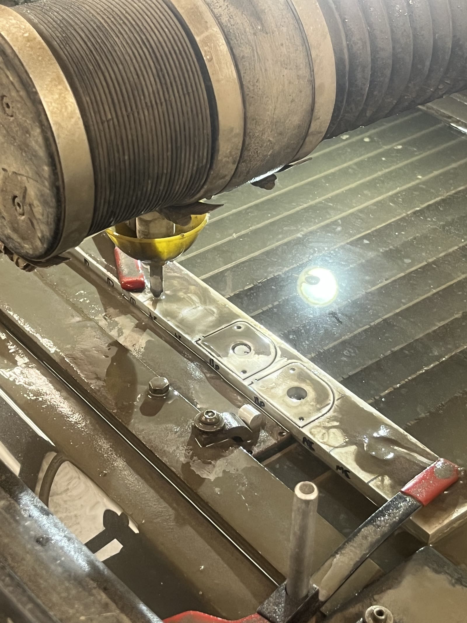 Waterjetting the mounting tabs — abrasive waterjet cutting the aluminum plate stock that the pedalbox tabs were nested into.