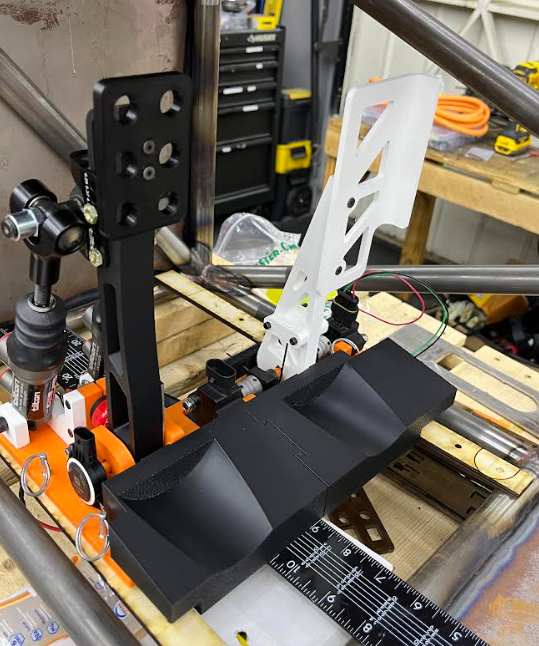 First prototype on the bench — 3D printed accelerator pedal and footrest mockup used to check BOTS packaging and spring feel.